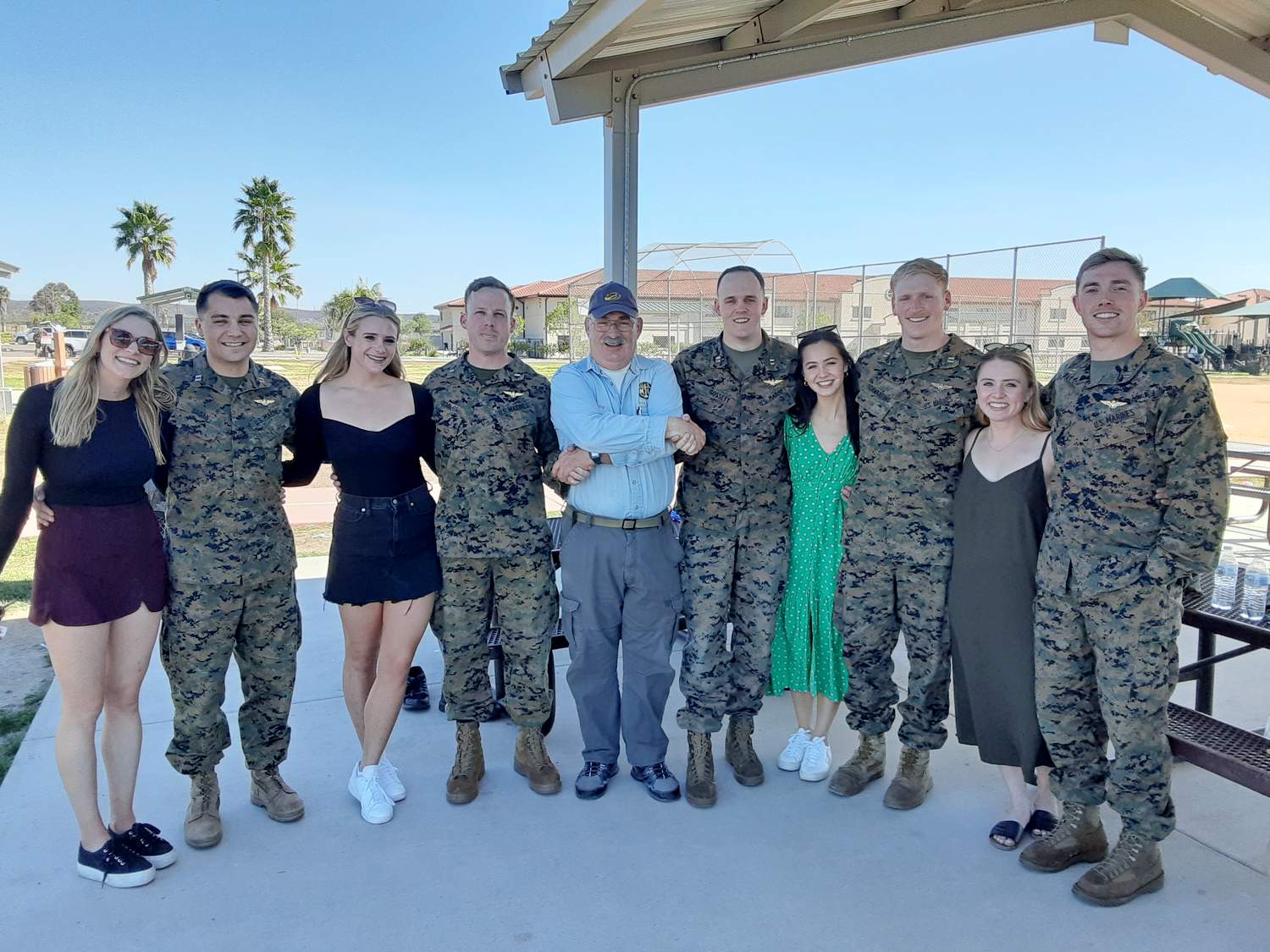 – Jay Rindler (c), Welcome Home Chair, welcomes home CH-53 pilots from HMH -462 along with their wives.
